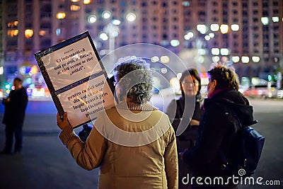 Elder woman with message at romanian protests, Bucharest, Romania Editorial Stock Photo