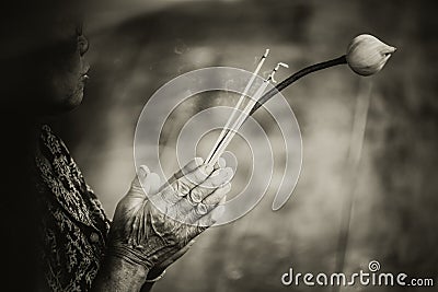 Elder woman Pray and Adore Buddha with Lotus. Stock Photo