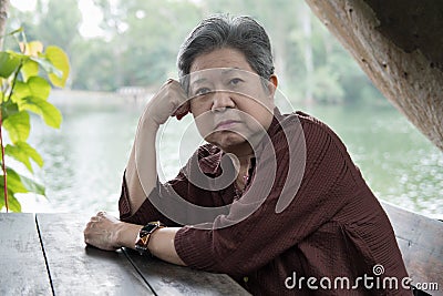 Elder woman resting in garden. elderly female relaxing in park. Stock Photo