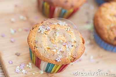 Elderflower muffin at an angle with two muffins blurred in background Stock Photo