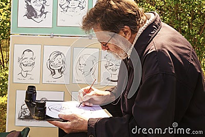 Elderly artist draws cartoons Editorial Stock Photo