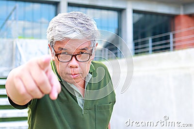 An elderly Asian man studying in university wearing eyeglasse Stock Photo