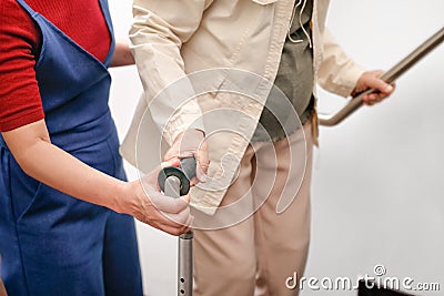 Elderly woman using a cane with daughter take care Stock Photo