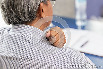 Elderly back neck and shoulder pain using hand to massage and rub Stock Photo