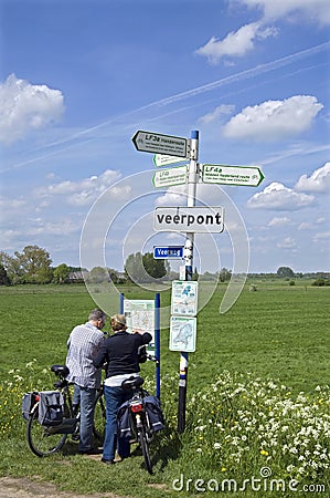 Elderly bikers reading road map in countryside Editorial Stock Photo