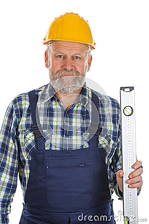Elderly builder with spirit level tool Stock Photo