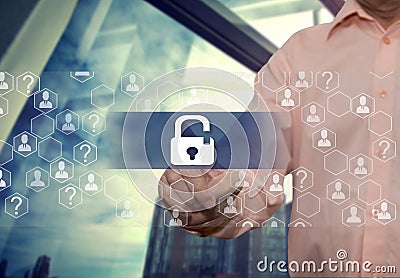 An elderly businessman chooses lock like security shield business on the Internet on the touch screen with a blur office backgrou Stock Photo