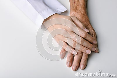 Elderly care concept, Young doctor holding senior patient hand to help and support, Family take care and nursing old people health Stock Photo