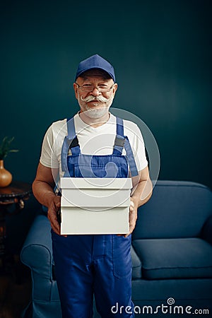 Elderly cargo man in uniform poses in home office Stock Photo