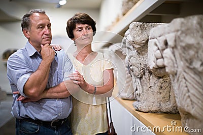 Elderly couple of tourists view exhibits in a museum Editorial Stock Photo