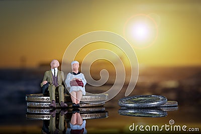 Elderly Couple Golden Age Inflation Pensions Sitting Coin Pile Sunset Miniature People Figures Stock Photo