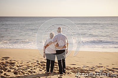 Elderly couple hugging each other on the beach Editorial Stock Photo
