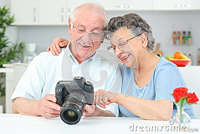 Elderly couple looking at pictures Stock Photo