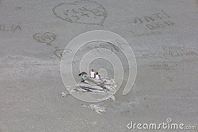 Elderly couple resting on the sand beach Stock Photo