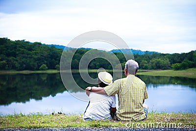 Elderly couple sit together happily. Stock Photo