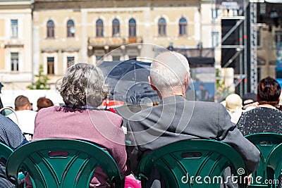 Elderly couple watching an outdoor show Editorial Stock Photo