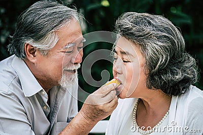 Elderly Couples eating some fruit Stock Photo