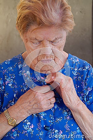 elderly disabled woman getting dressed. Apraxia. loneliness in old age Stock Photo