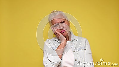 An elderly European woman with a sad expression experiences discomfort and sorrow Stock Photo