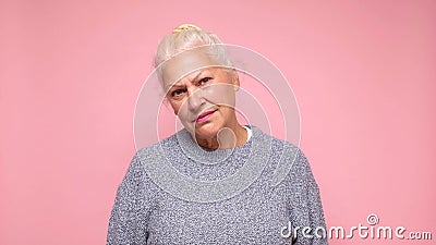An elderly European woman with a sad expression experiences discomfort and sorrow Stock Photo