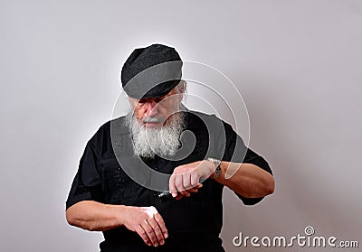 Elderly gentleman inspecting his hand Stock Photo