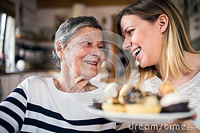 An elderly grandmother with an adult granddaughter at home. Stock Photo