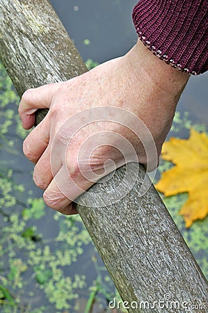 The elderly grandmother his right hand hold on to the railings o Stock Photo