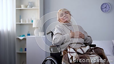 Elderly handicapped woman feeling chest pain, heart arrhythmia, health care Stock Photo