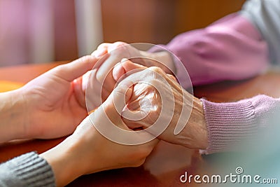 Elderly hands. Helping hands of young adult and senior women. Care and elderly concept. Stock Photo