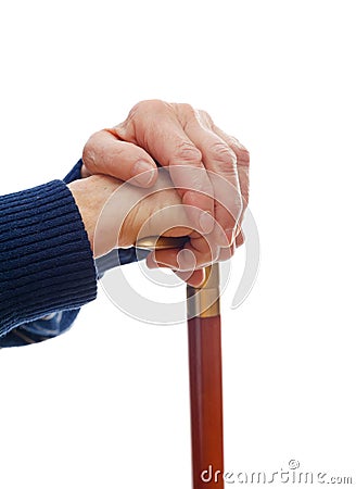 Elderly hands resting on stick Stock Photo