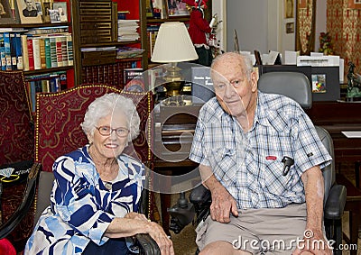 Elderly happily married couple celebrating the wife`s 87th birthday in their home. Stock Photo