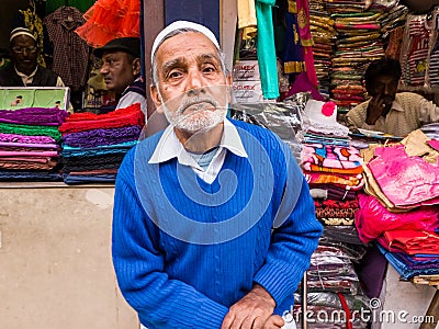 An elderly Indian shopkeeper sitting outside his store Editorial Stock Photo