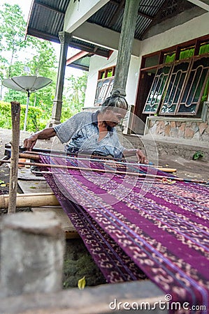 Elderly Indonesian lady works on the loom Editorial Stock Photo