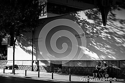 Elderly Ladies Resting Under Advertising Board Editorial Stock Photo