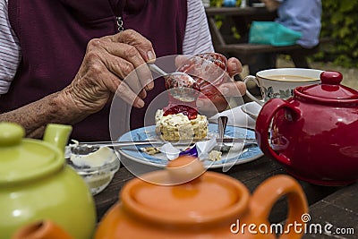 Elderly lady enjoying cream tea Stock Photo