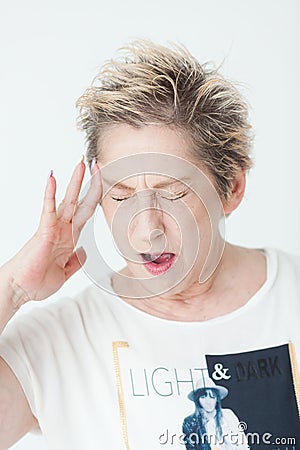 Elderly lady in excruciating headache or memory loss Stock Photo