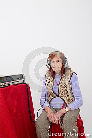 Elderly lady listening to the radio Stock Photo