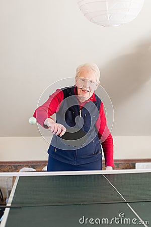 An elderly lady playing table tennis Stock Photo