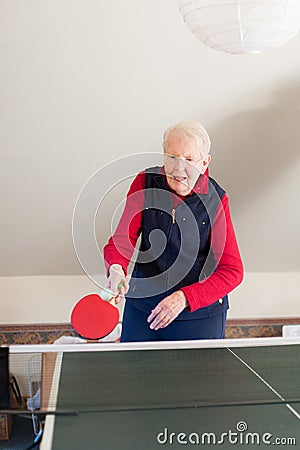 An elderly lady plays table tennis Stock Photo