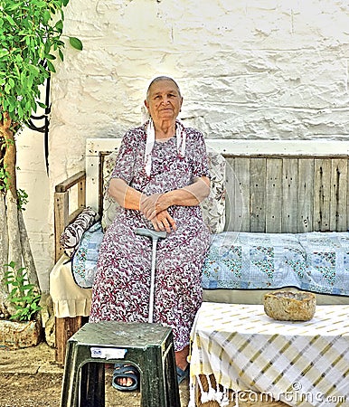 Elderly lady sitting in her garden Editorial Stock Photo