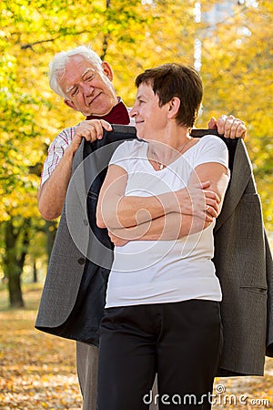 Elderly man caring about his wife Stock Photo