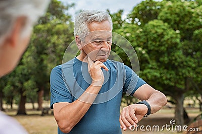 Elderly man checking pulse after running Stock Photo