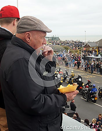 Elderly man eats chips Editorial Stock Photo