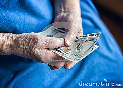 Elderly man holding money in his hand Stock Photo