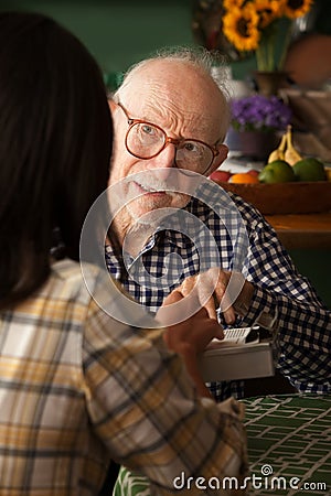 Elderly man in home with provider or survey taker Stock Photo