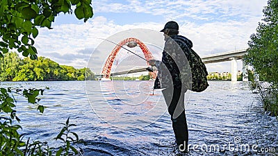 an elderly man in long boots fishing on the river- Moscow, Silver Forest in Moscow Editorial Stock Photo