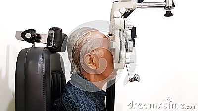 Elderly man measuring his eyesight with phoropter Stock Photo