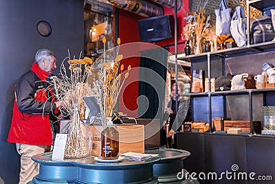 Elderly man paying bill at cash counter in decorated hotel of luxurious resort Editorial Stock Photo