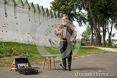 An elderly man playing the russian accordion. Suzdal, Russia Editorial Stock Photo