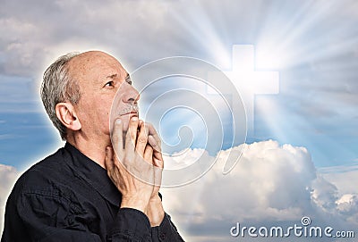 Elderly man praying Stock Photo